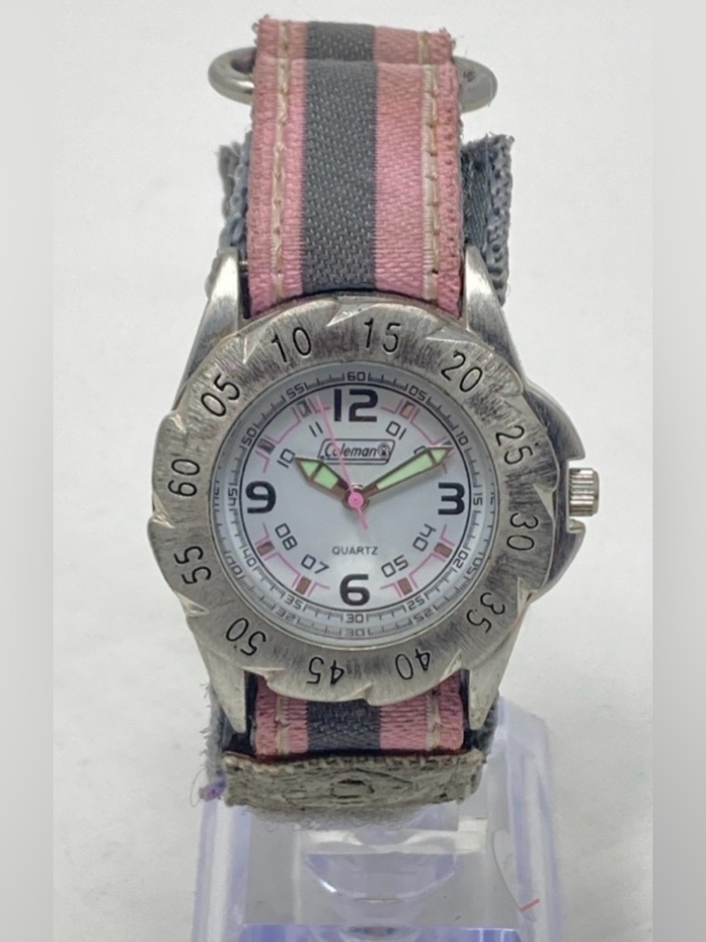 Coleman quartz watch features a pink and gray nylon band